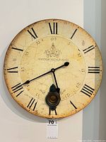 Full view of round wall clock showing dial and hands