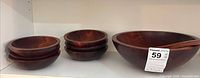 Large salad bowl and six small bowls on shelf