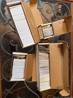 Three open cardboard long boxes filled with stacked football trading cards
