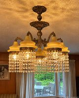 Chandelier installed showing five ivory glass shades and crystal prisms
