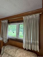 Small window showing full curtain set on rod