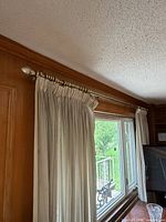 Rod installed over window with curtains attached