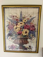 Full view of framed tile mural hanging on wall