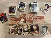 Three stacks of assorted hockey trading cards and spread of sepia photo cards