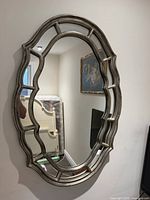 front view of oval mirror on wall showing full frame