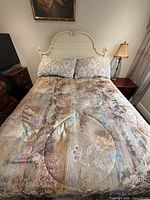 Full view of bed with comforter and shams