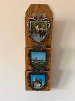 Full view of wooden wall organizer with three metal-trimmed frames and pockets