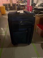 Front view of navy Samsonite suitcase showing exterior pockets and brand badge