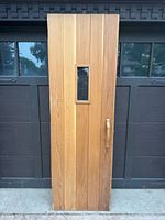 Full front view of cedar door showing window and handle