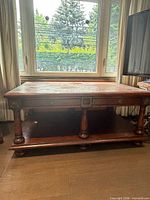 Front view showing overall table shape, drawers, legs, finish