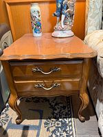 Front and side view showing cabriole legs, two drawers, ornate pulls, overall finish