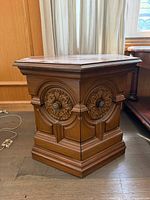 Front view showing carved panels and hexagonal shape