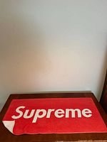 Full view of towel laid flat showing Supreme logo
