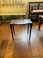 Full view of the side/end table showing turned legs and scalloped top edge