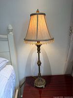 Full view of lamp illuminated on bedside table