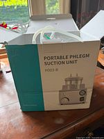 Box showing product name Portable Phlegm Suction Unit H003-B