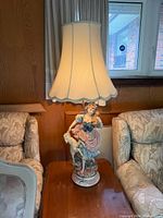 Full view of lamp on side table between sofas