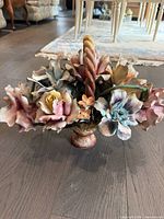 Front view showing full arrangement of multicolor porcelain flowers, twisted handle and pedestal base