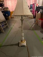 Full view of lamp showing base, column, shade with bead fringe
