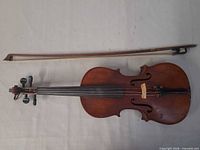 Violin full view with bow alongside