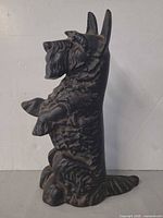 Full left profile of cast iron dog doorstop