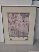Full view of framed Faust lithograph poster with mat and silver frame