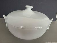 Side view showing bowl, lid and handles