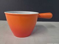 Side profile showing orange exterior and handle