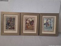 Front view showing three framed prints side by side