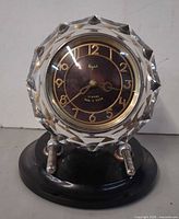 Front view showing dial, crystal surround, supports and base