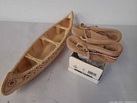 Canoe, moccasins on box overview
