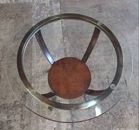 Overhead view of round glass top and wood shelf