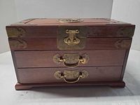 Front view showing brass latch, handles and two drawers