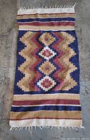 Full view of wool runner rug showing pattern and fringe