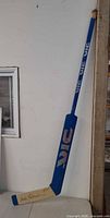 Full view of VIC Pro goalie stick leaning against wall