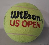 Front view showing Wilson US OPEN branding on fluorescent yellow felt
