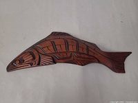 Full view of carved wooden fish wall art