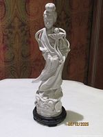 Full view of Blanc de Chine porcelain figurine on wooden stand