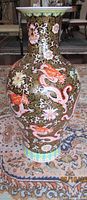 Full view of tall black-ground porcelain vase with dragon and floral decoration