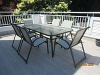 Table and six chairs assembled on patio