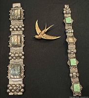 Two sterling bracelets and swallow brooch overview