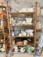 Full shelving unit showing majority of mixed ceramics and glass