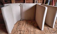Six beige tan chaise lounge cushions arranged upright to show fronts