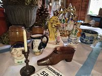 Overall view showing Staffordshire groups, Toby jugs, wooden boxes, shoe snuff, candlestick, transferware cup