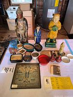 Overall lot view showing figures, cloisonné pieces, planters, bowls, framed textile