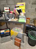Overview of desk with notebooks, organizers, tape, plastic cases