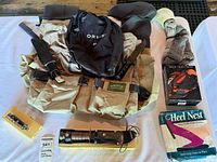 All items laid out including waders, bag, knives, traction cleats, Heel Nest, socks