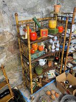 Full view of four-tier bamboo etagere with decorative items on shelves