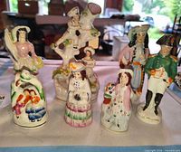 All eight figurines front view