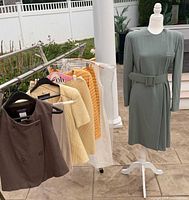Full view of all garments on rack and mannequin